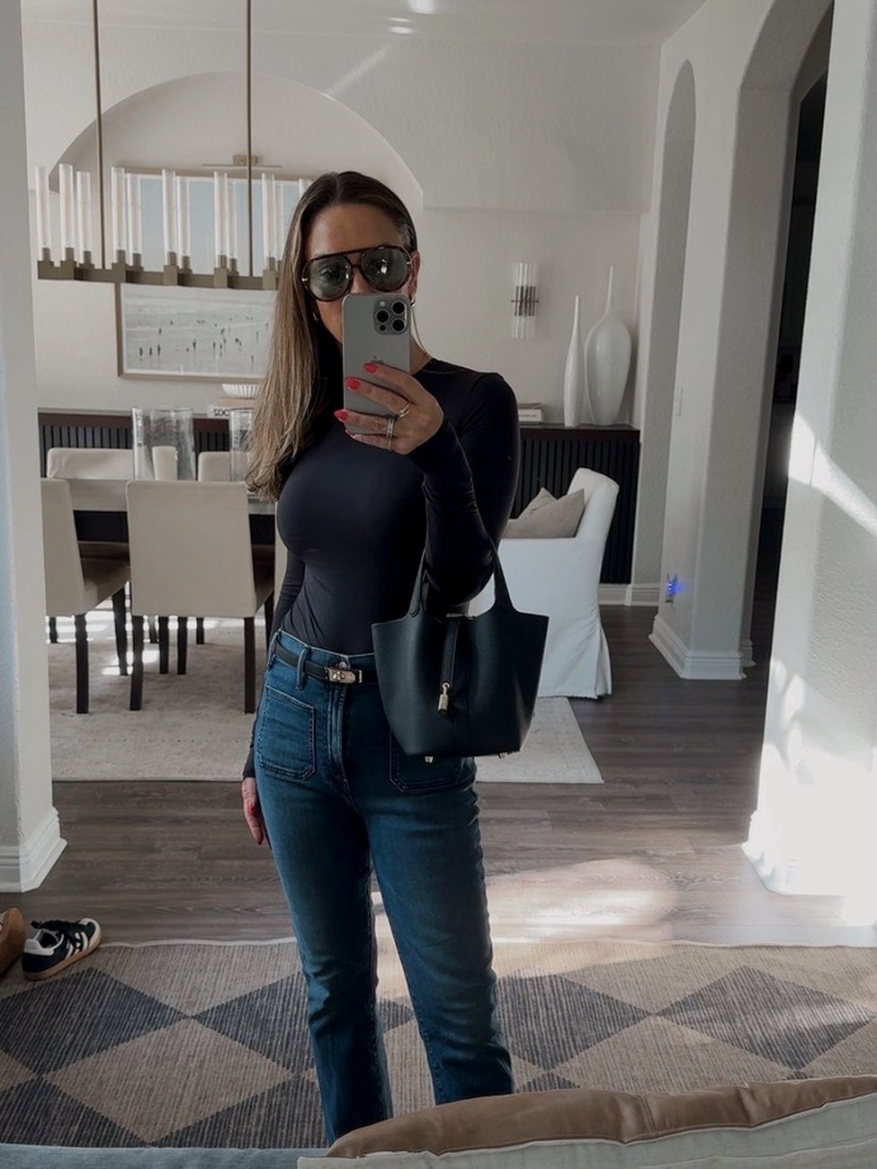 Jen in a black top and jeans, shop on ShopMy